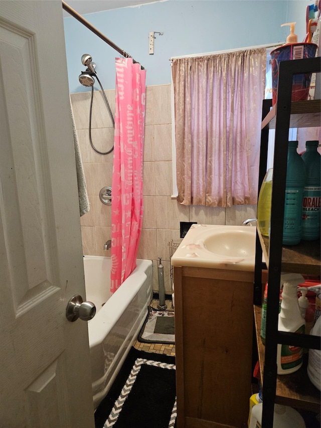 full bathroom with shower / bath combination with curtain, tile walls, and vanity