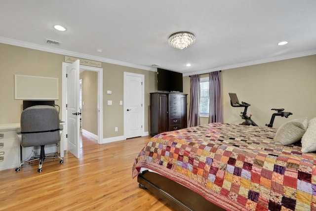 bedroom with baseboards, light wood-style floors, visible vents, and ornamental molding