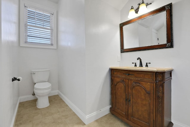 bathroom featuring tile patterned flooring, toilet, vanity, and baseboards