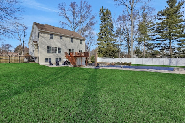 back of property featuring a fenced backyard, stairs, a deck, a patio area, and a lawn