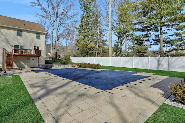 view of swimming pool with a wooden deck, a patio, a fenced backyard, and stairs