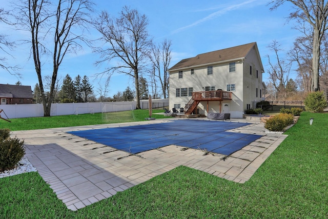 exterior space with stairway, a wooden deck, a fenced backyard, a patio area, and a lawn