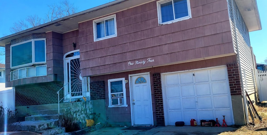 view of front of house with a garage and brick siding