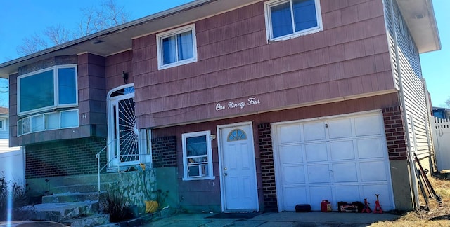 view of front of house with a garage and brick siding