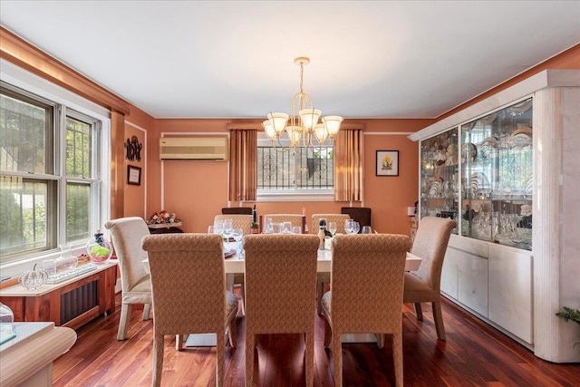 dining room with a notable chandelier, wood finished floors, and a wall mounted AC