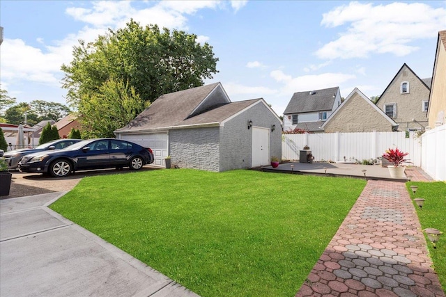 view of yard featuring a garage, an outdoor structure, and fence