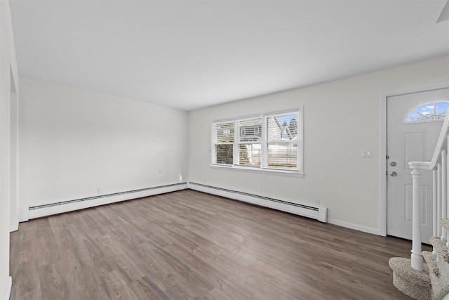 entryway with a baseboard heating unit, baseboards, stairs, baseboard heating, and wood finished floors