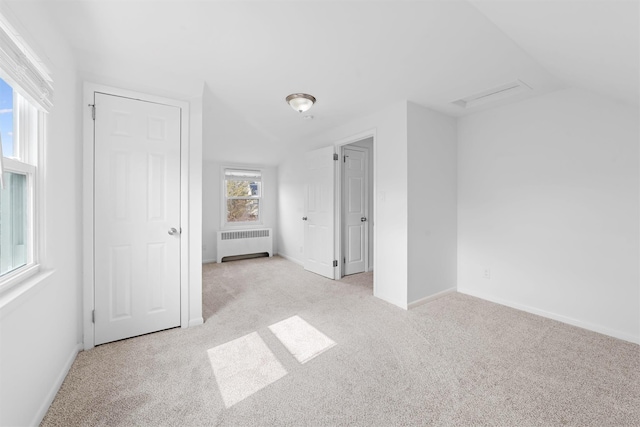 unfurnished bedroom featuring radiator, carpet, and baseboards