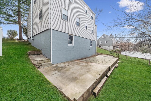 rear view of property featuring a patio and a yard