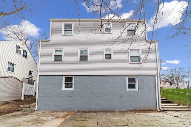 back of house featuring a patio, fence, and stucco siding