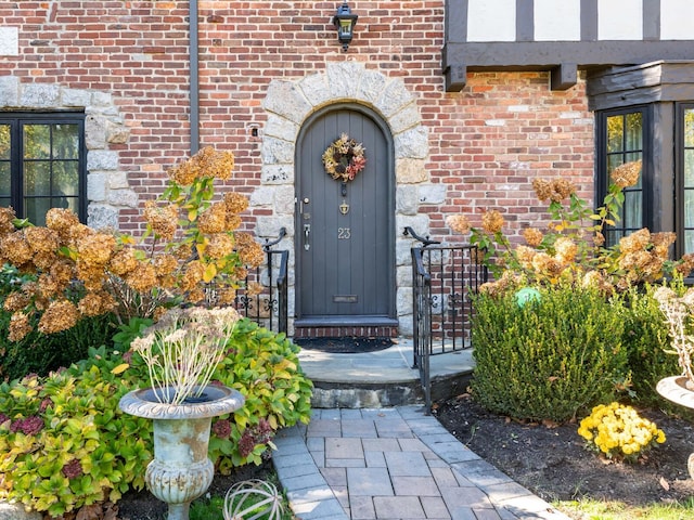 entrance to property featuring brick siding