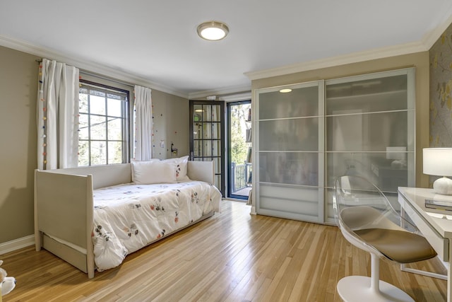 bedroom with baseboards, hardwood / wood-style floors, crown molding, and access to exterior