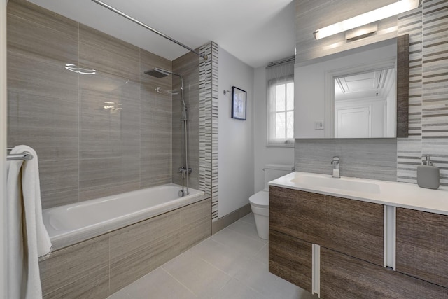 bathroom with toilet, tiled shower / bath combo, tile patterned flooring, decorative backsplash, and vanity