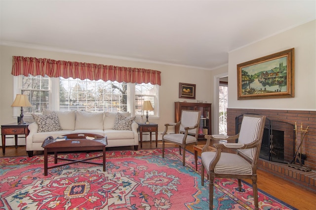 living area with plenty of natural light, a fireplace, a baseboard heating unit, and wood finished floors