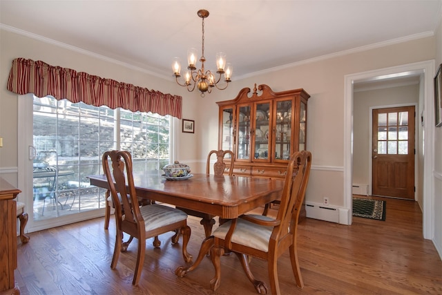 dining area featuring a healthy amount of sunlight, an inviting chandelier, and wood finished floors