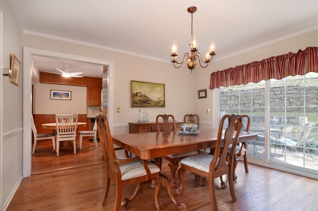 dining room featuring ceiling fan with notable chandelier, light wood finished floors, and ornamental molding