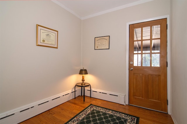 entryway featuring a baseboard heating unit, crown molding, and wood finished floors