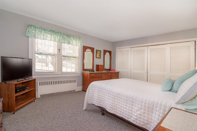 bedroom featuring a closet, radiator heating unit, and carpet floors