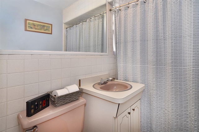 bathroom featuring vanity, tile walls, toilet, and a shower with shower curtain