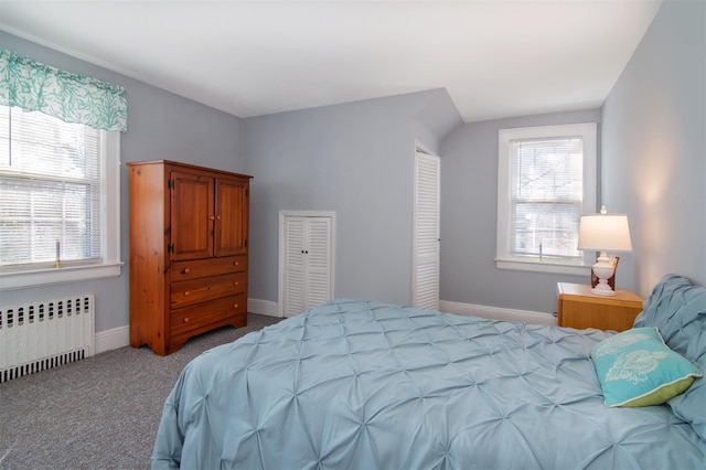 carpeted bedroom featuring multiple windows, radiator, and baseboards