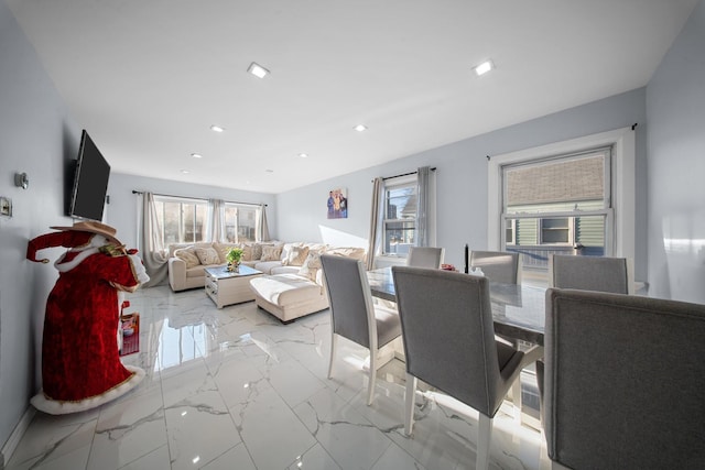 living area with recessed lighting, a healthy amount of sunlight, and marble finish floor