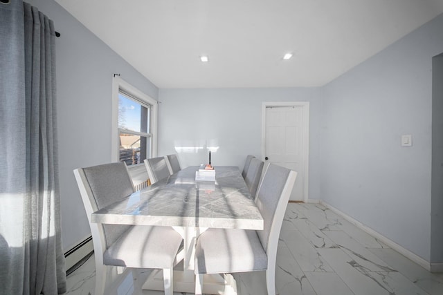 dining room featuring a baseboard heating unit, baseboards, and marble finish floor