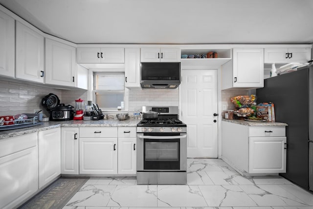 kitchen with white cabinetry, marble finish floor, backsplash, and stainless steel appliances