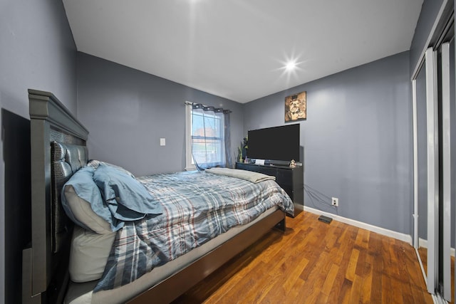 bedroom featuring baseboards and wood finished floors