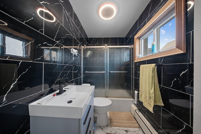 bathroom with vanity, tile walls, toilet, marble finish floor, and baseboard heating