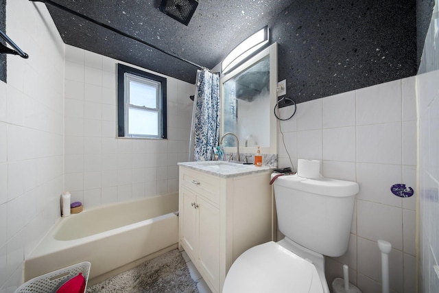 full bath with shower / bathtub combination with curtain, toilet, tile walls, and vanity