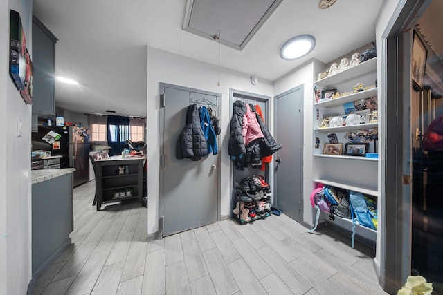 interior space with wood finish floors and attic access