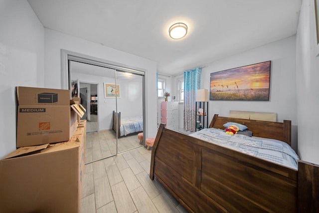 bedroom with a closet and wood finish floors