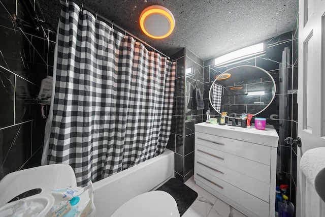 full bathroom featuring vanity, shower / bath combo, a textured ceiling, toilet, and marble finish floor