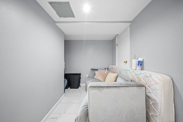 interior space with baseboards and marble finish floor