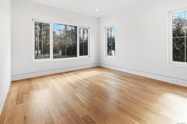 spare room with recessed lighting and wood finished floors