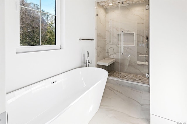 bathroom featuring a soaking tub, marble finish floor, and a marble finish shower