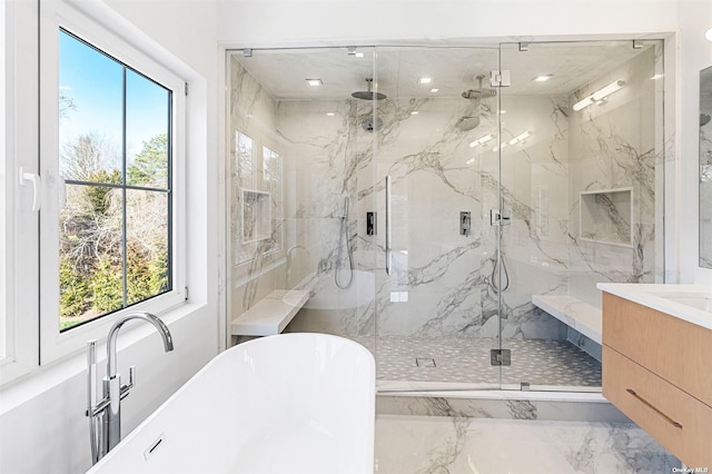 full bath with vanity, marble finish floor, a marble finish shower, and a freestanding bath