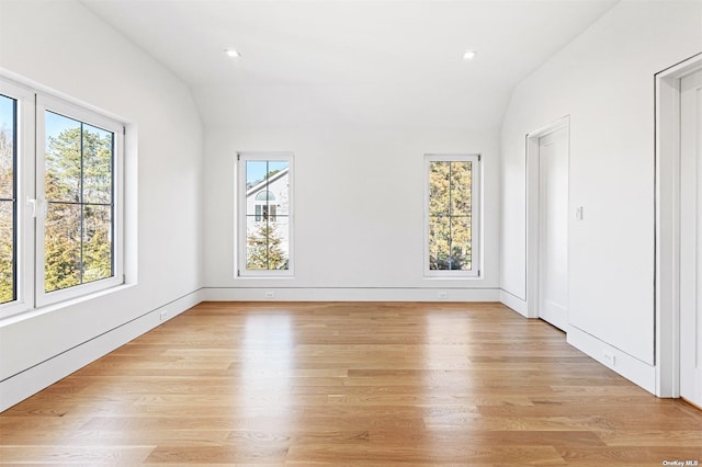 unfurnished room featuring lofted ceiling, light wood-style flooring, and recessed lighting