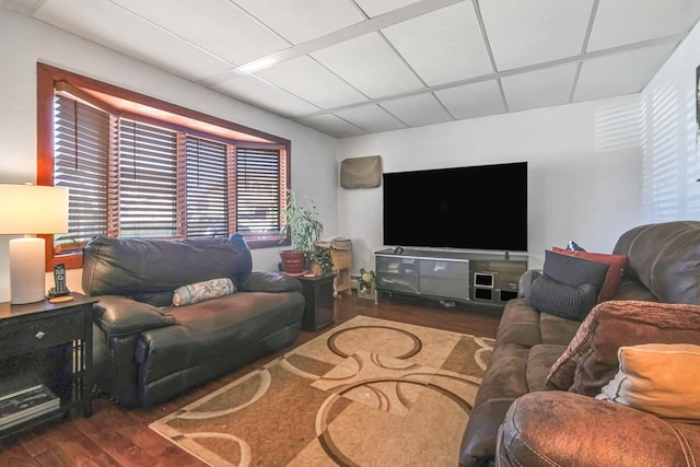 living room with a paneled ceiling and wood finished floors