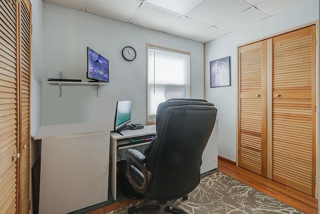 office area with wood finished floors and a drop ceiling