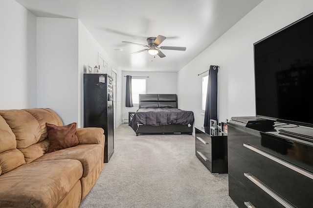 bedroom with light carpet, refrigerator with ice dispenser, and ceiling fan