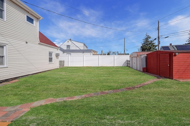 view of yard featuring an outdoor structure, a storage unit, and fence