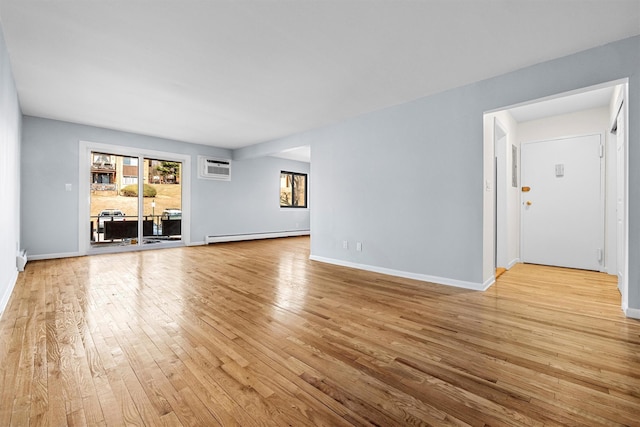 unfurnished living room featuring a wall mounted air conditioner, a baseboard radiator, baseboards, and hardwood / wood-style floors