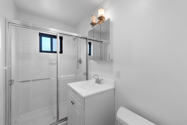 full bath featuring vanity, toilet, and a shower stall