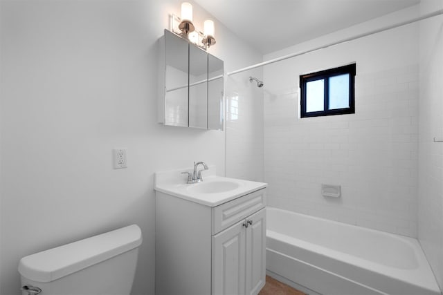 bathroom with toilet, vanity, and shower / tub combination