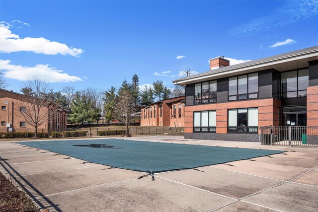 pool featuring a patio and fence