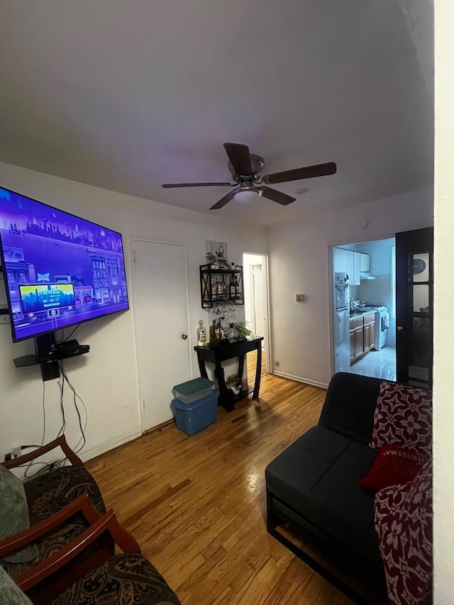 living room featuring baseboards and wood finished floors