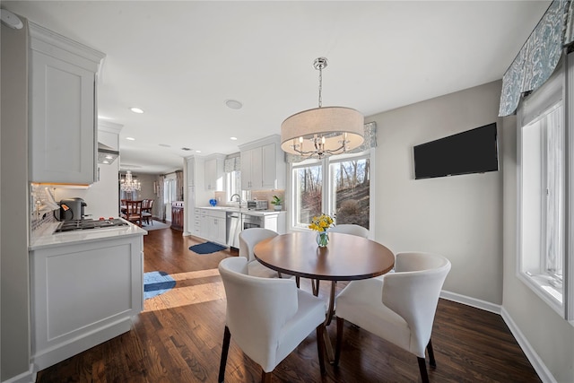 dining room with recessed lighting, baseboards, dark wood-type flooring, and a chandelier