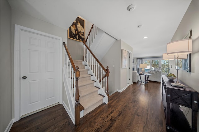 stairs with recessed lighting, baseboards, and wood finished floors