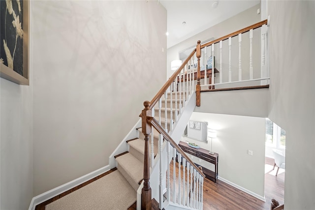 stairs with baseboards and wood finished floors